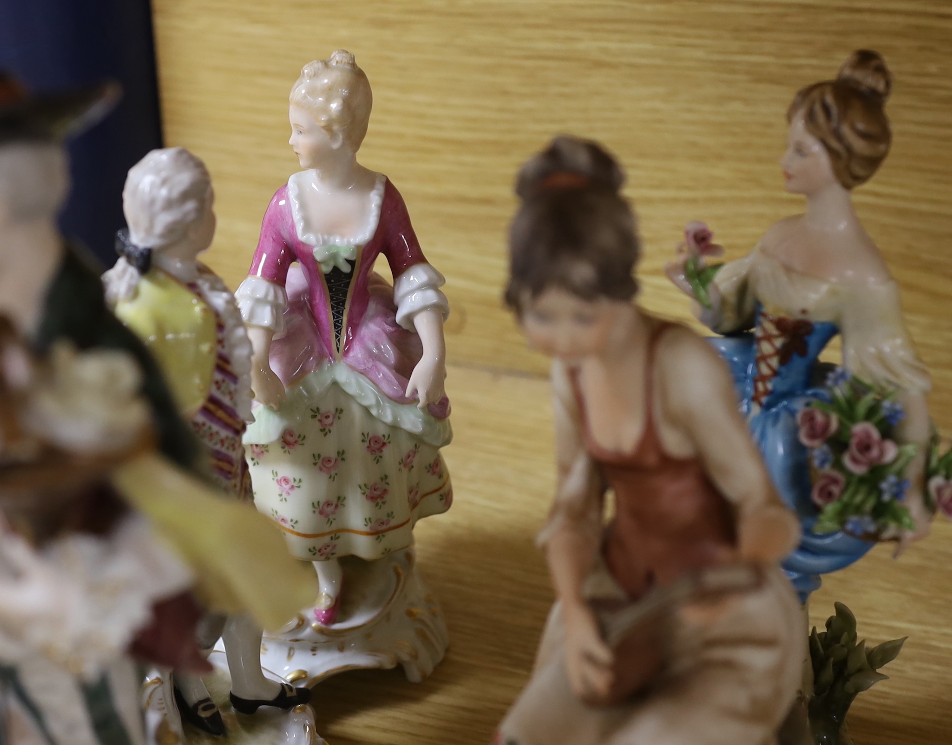 A collection of various porcelain figures including Coalport, Doulton etc. and two dessert plates